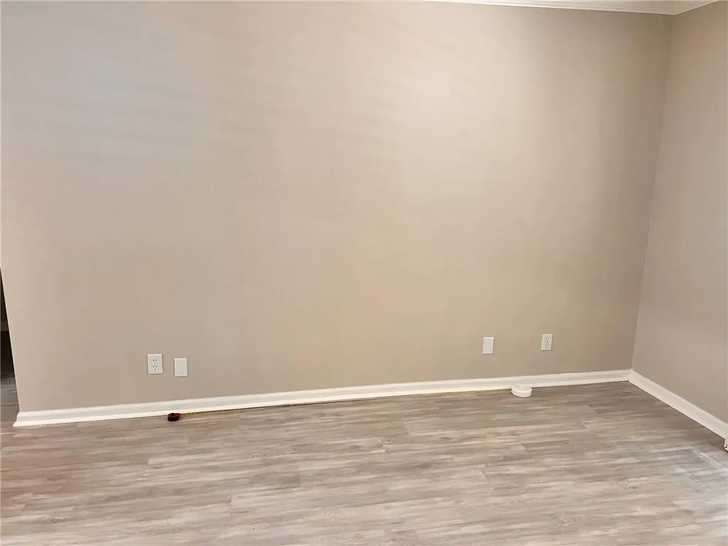 Empty room with light wood-style floors and baseboards