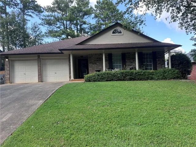Brick exterior with a covered front porch supported by columns
