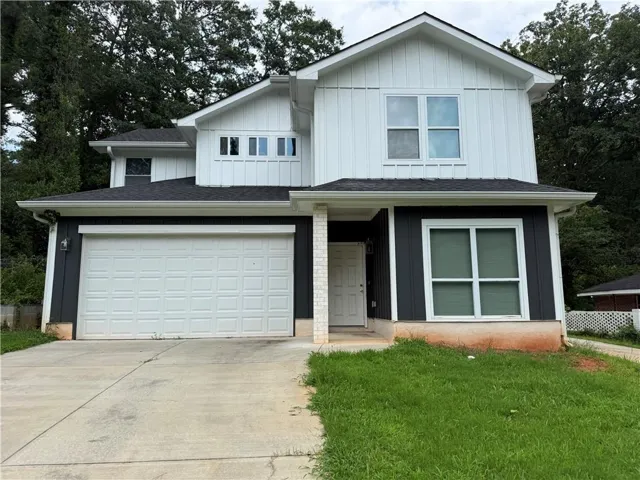 Two-story exterior with dark gray and white siding