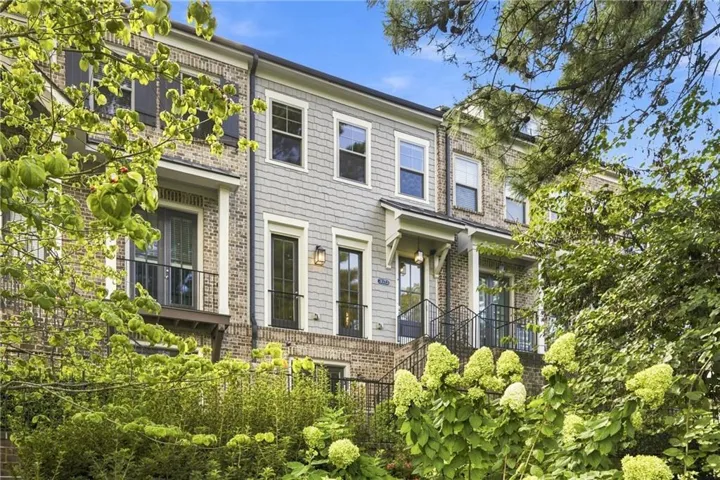 Brick and siding exterior with multiple balconies and exterior lighting