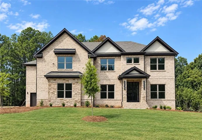 Two-story brick and stone exterior with a gabled roofline
