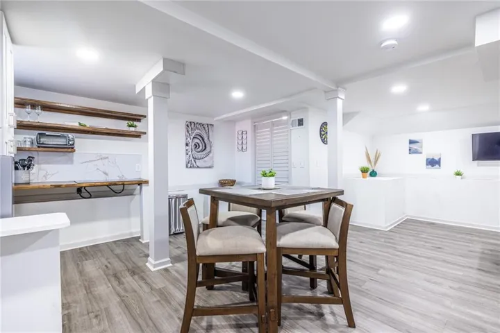 Dining area with radiator and light wood-type flooring