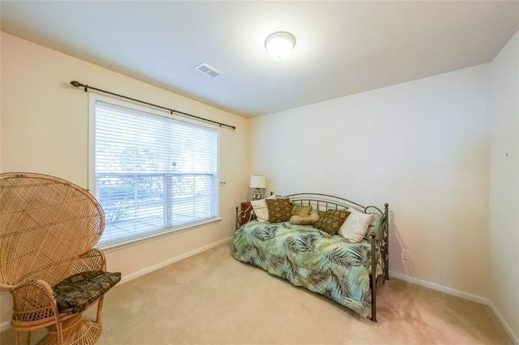 Carpeted bedroom featuring baseboards