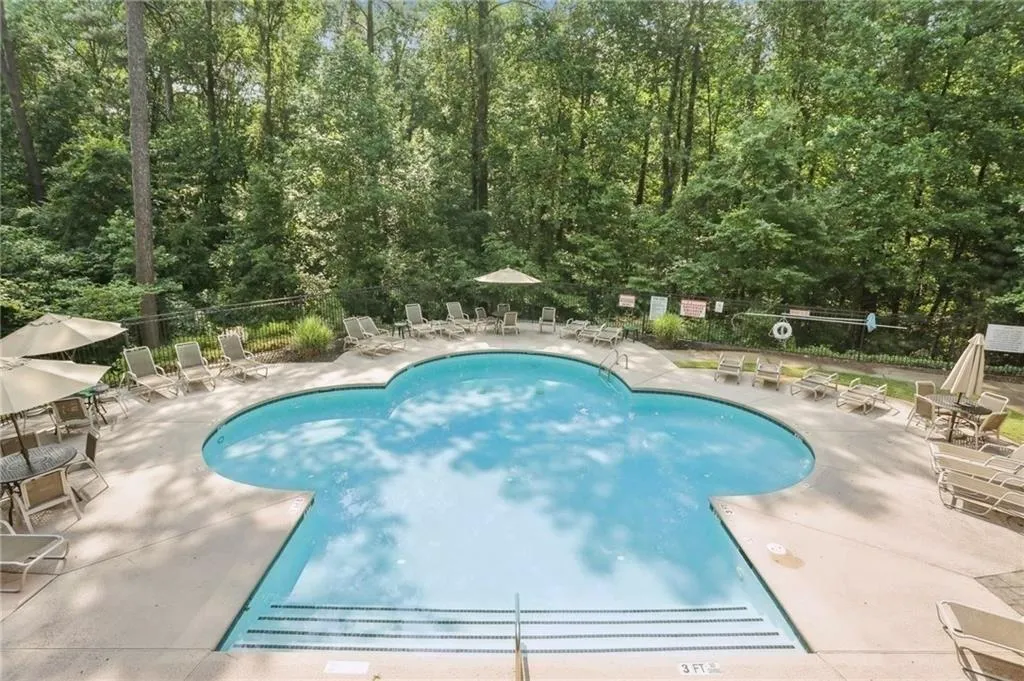 Community pool with a patio