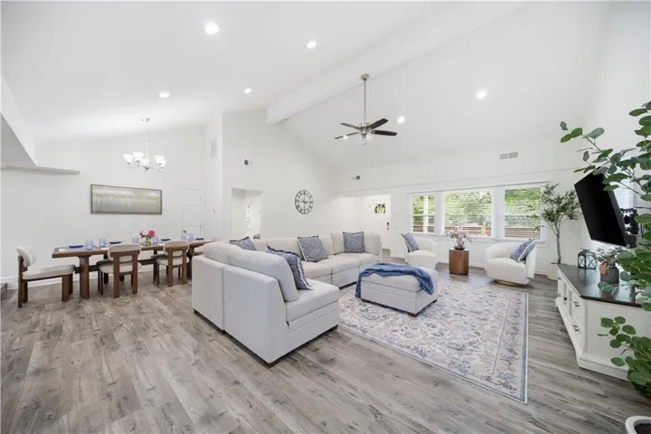 Spacious interior with vaulted ceilings, recessed lighting, and wood-finish flooring