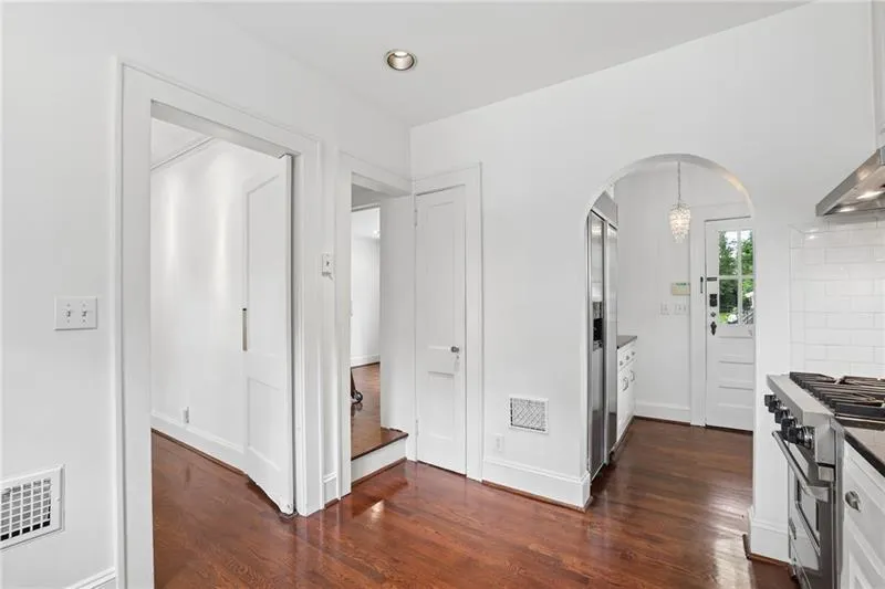 Hardwood flooring, recessed ceiling lighting, built-in shelving, built-in desk, and a rolling ladder