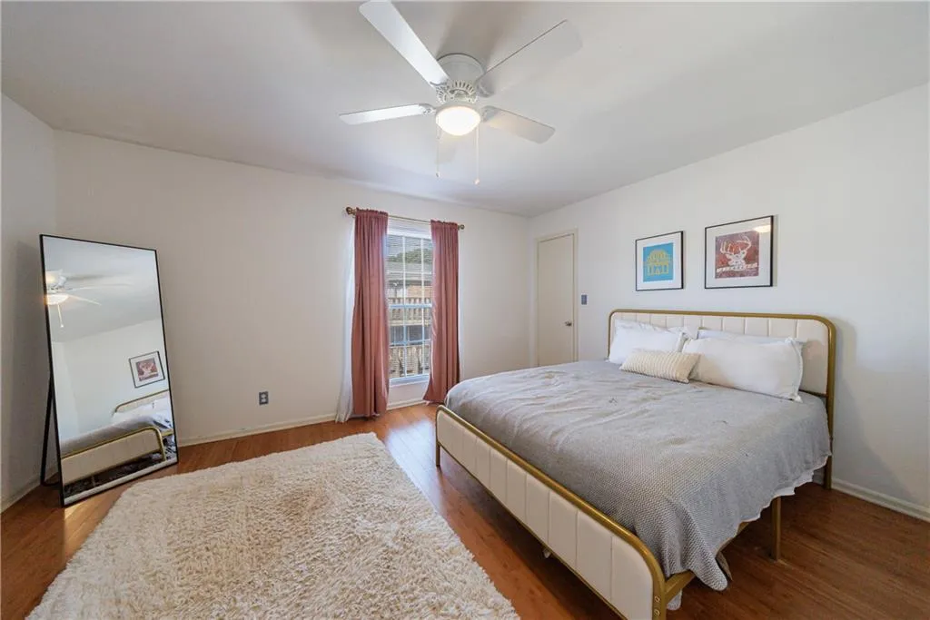 Bedroom featuring ceiling fan and wood finished floors