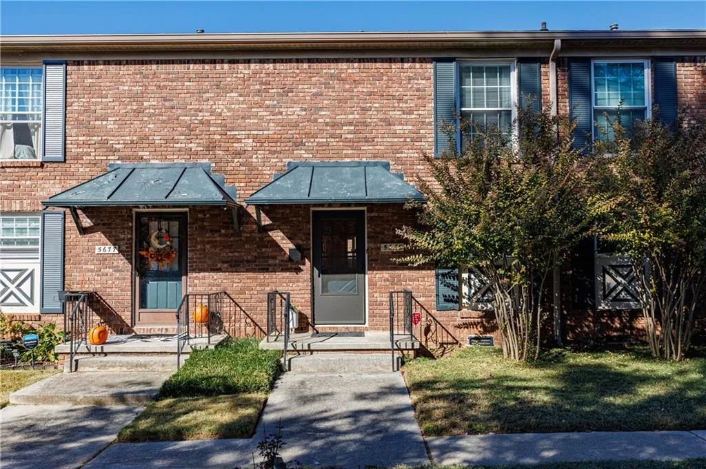View of front facade featuring brick siding and a front yard