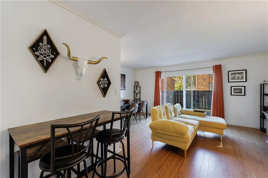 Living room with crown molding and hardwood / wood-style flooring