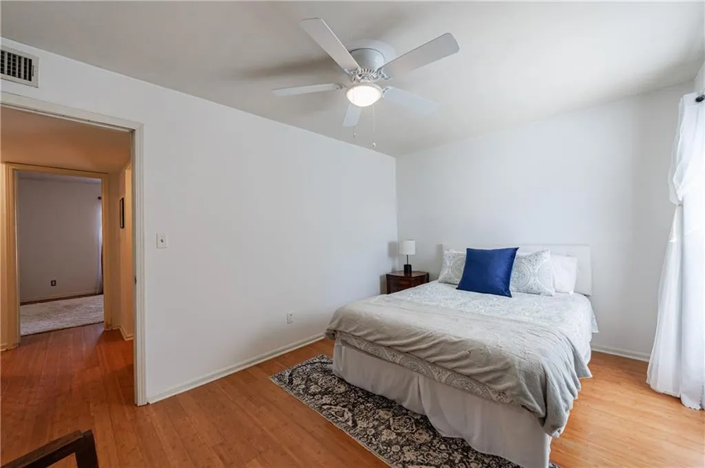 Bedroom featuring wood finished floors and a ceiling fan