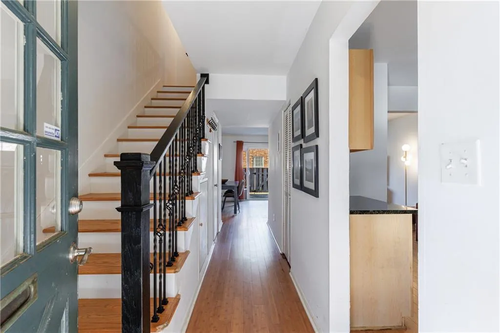 Hallway with light wood-style flooring and stairway