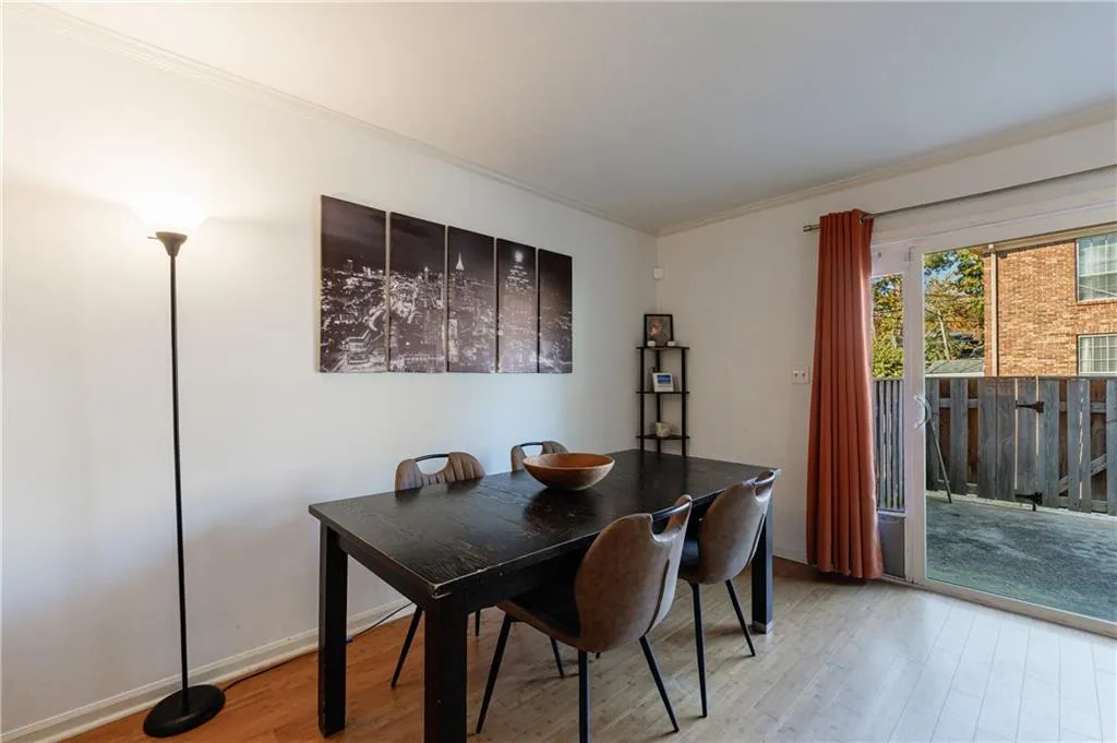 Dining space with light wood finished floors and ornamental molding