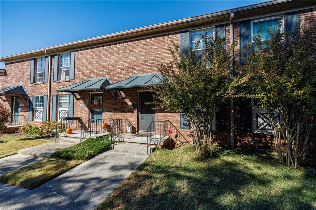 View of front of house with a front yard and brick siding