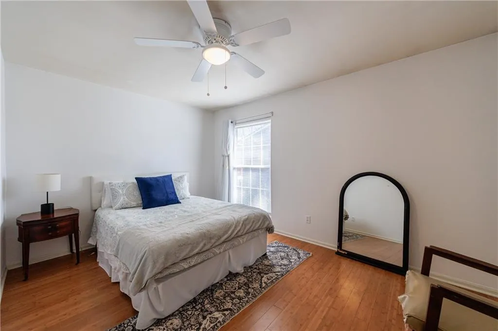 Bedroom featuring wood-type flooring and a ceiling fan