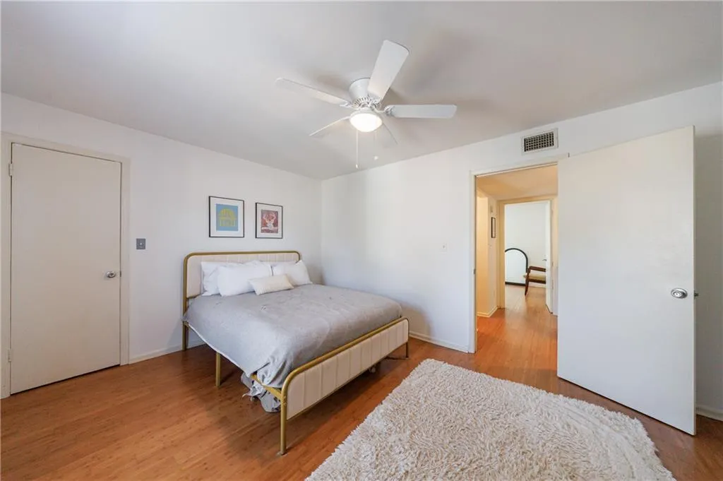Bedroom with light wood-style floors and ceiling fan
