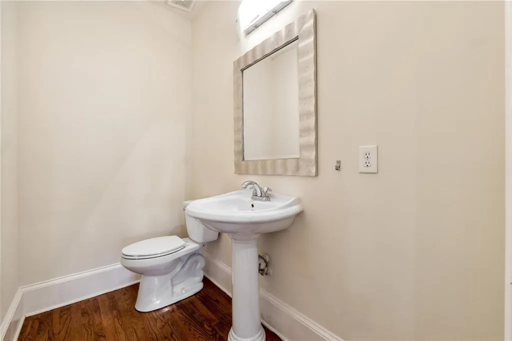Bathroom featuring toilet and wood-type flooring