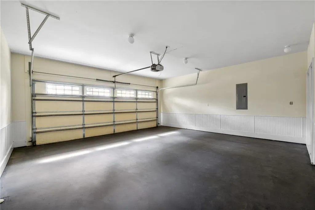 Garage with electric panel and a garage door opener