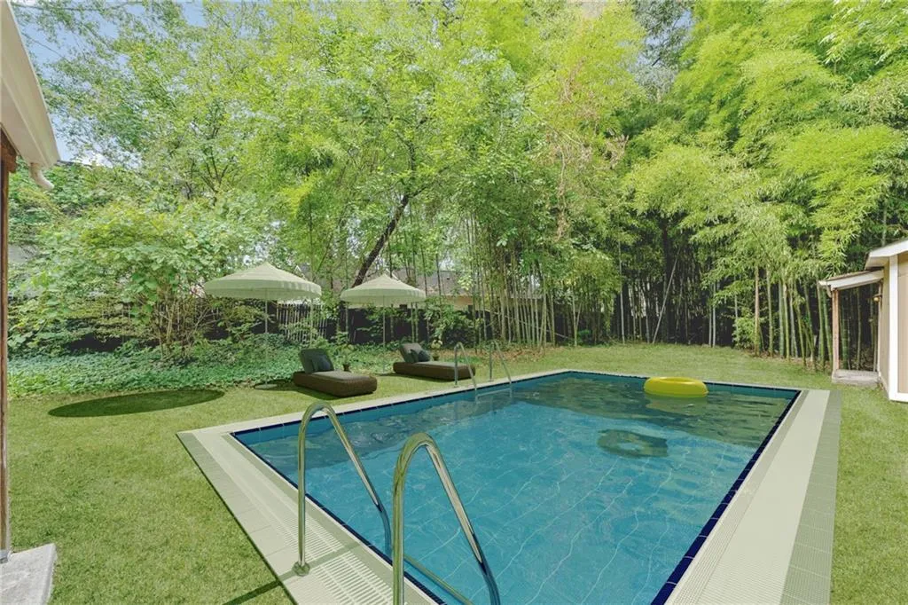 View of swimming pool featuring a lawn