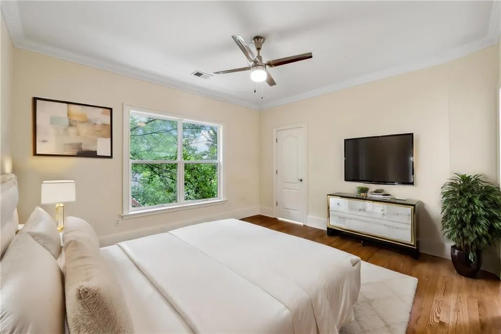 Bedroom featuring crown molding, ceiling fan, and wood-type flooring
