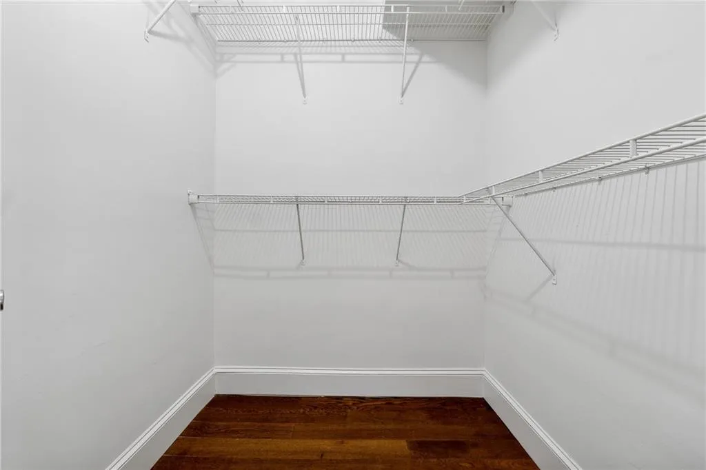 Spacious closet featuring hardwood / wood-style floors