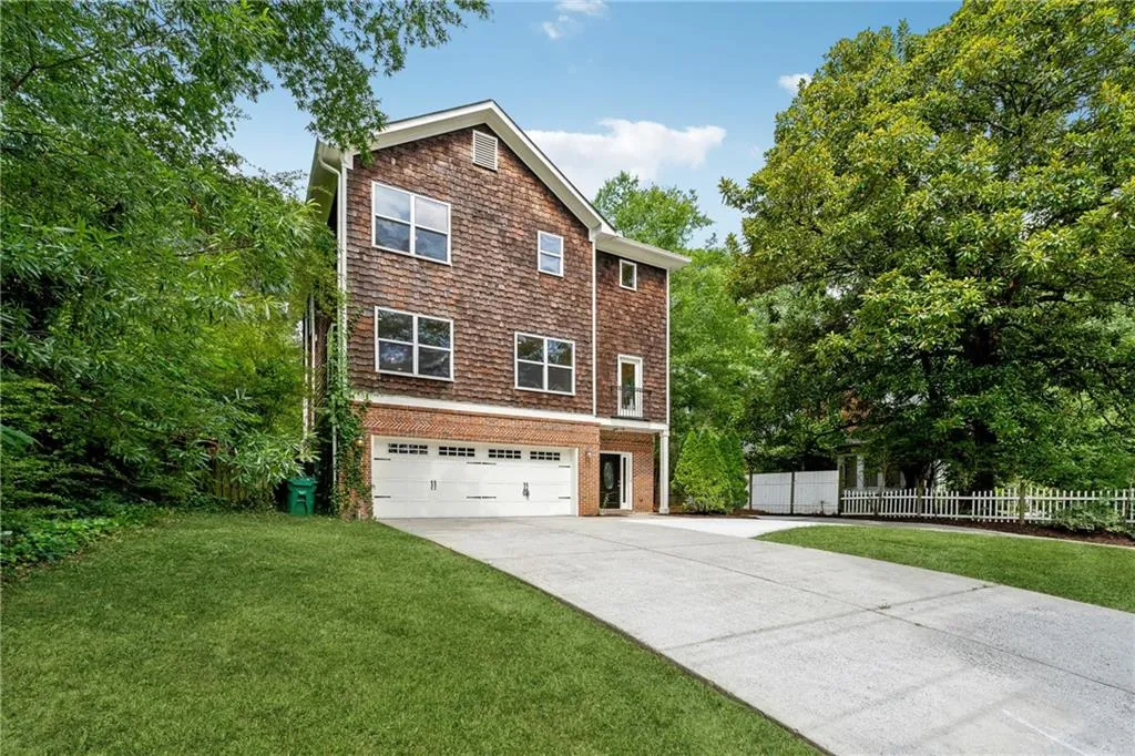 View of front of home featuring a garage and a front lawn