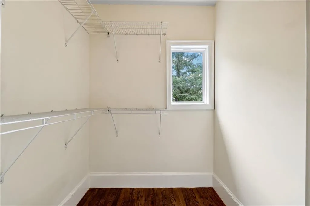 Spacious closet featuring hardwood / wood-style floors