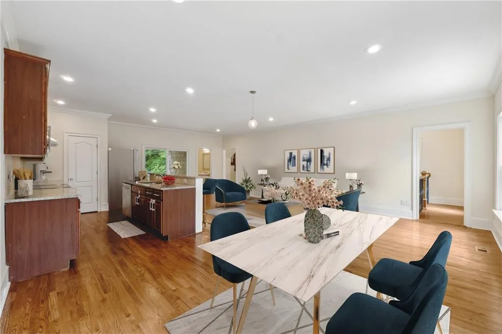 Dining room with sink, crown molding, and hardwood / wood-style floors