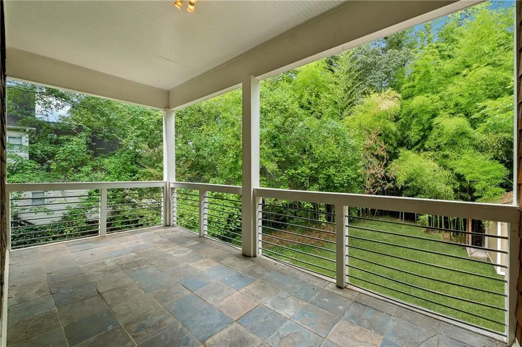 View of patio featuring a balcony