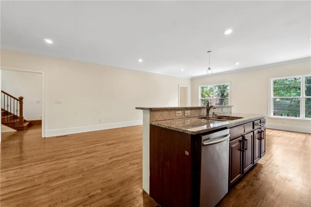 Kitchen with sink, wood-type flooring, and dishwasher