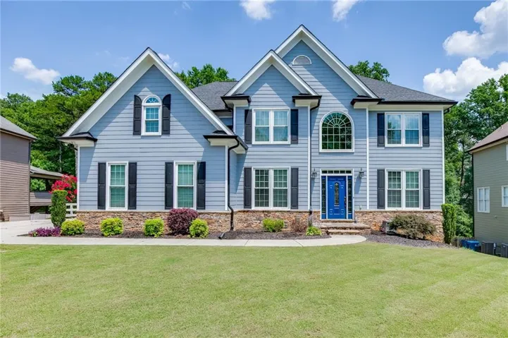 Front elevation with beautiful curb appeal landscaped yard and side entry garage.