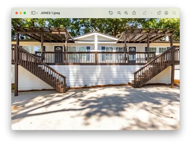 Back of property featuring stairs and a pergola