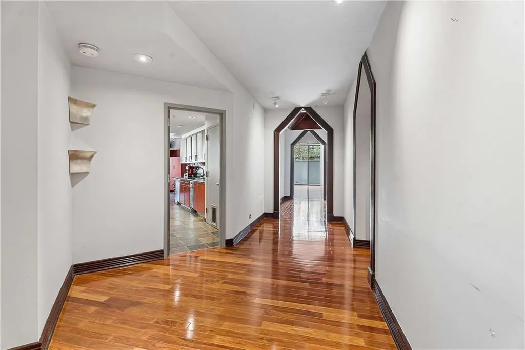 Hall featuring light wood-style flooring and baseboards