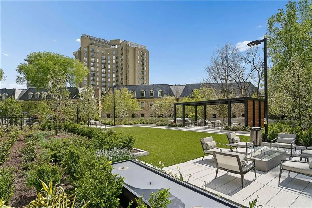 View of property's community with a patio area, a fire pit, and a pergola