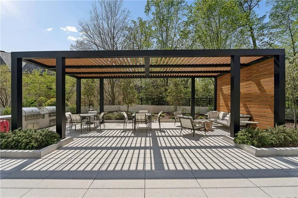 View of home's community with an outdoor living / dining area and area for grilling