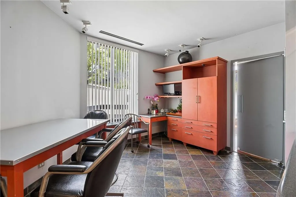 Office with stone tile floors and built in study area