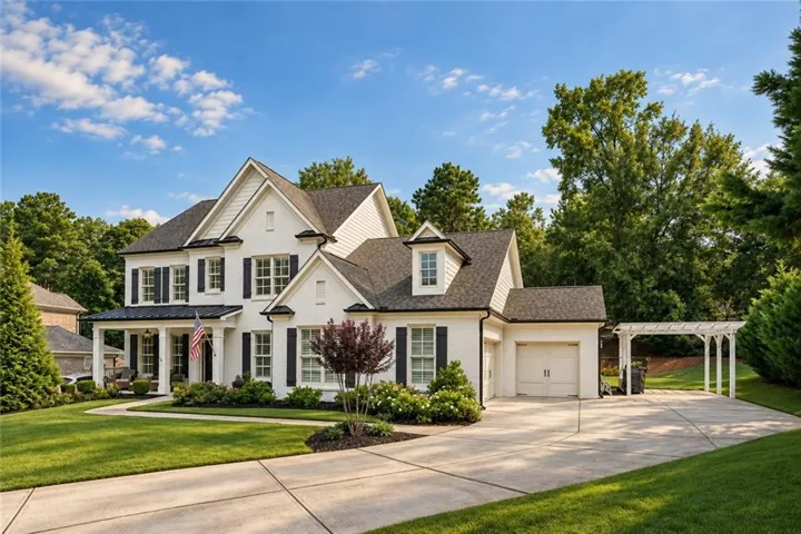 White brick exterior with dark shutters, covered front porch, attached garage, and pergola-covered parking