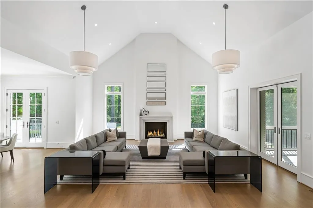 Vaulted fireside living room flows effortlessly from the kitchen and flanked by sunlit breakfast area, screened in porch, dining room and formal living area.