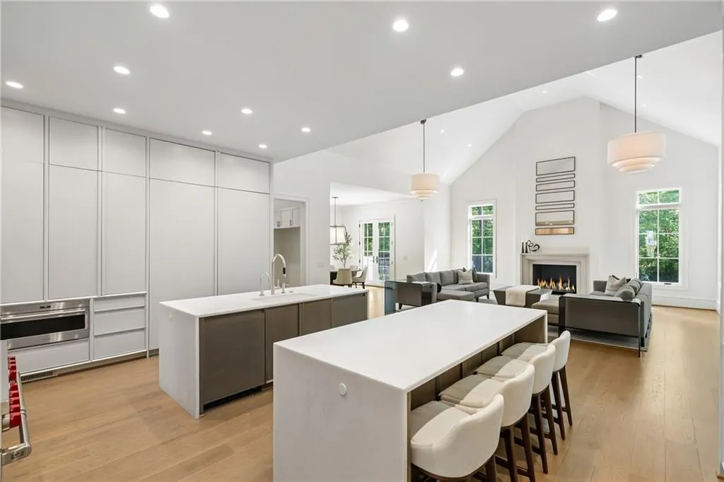 Double islands with marble waterfall countertops