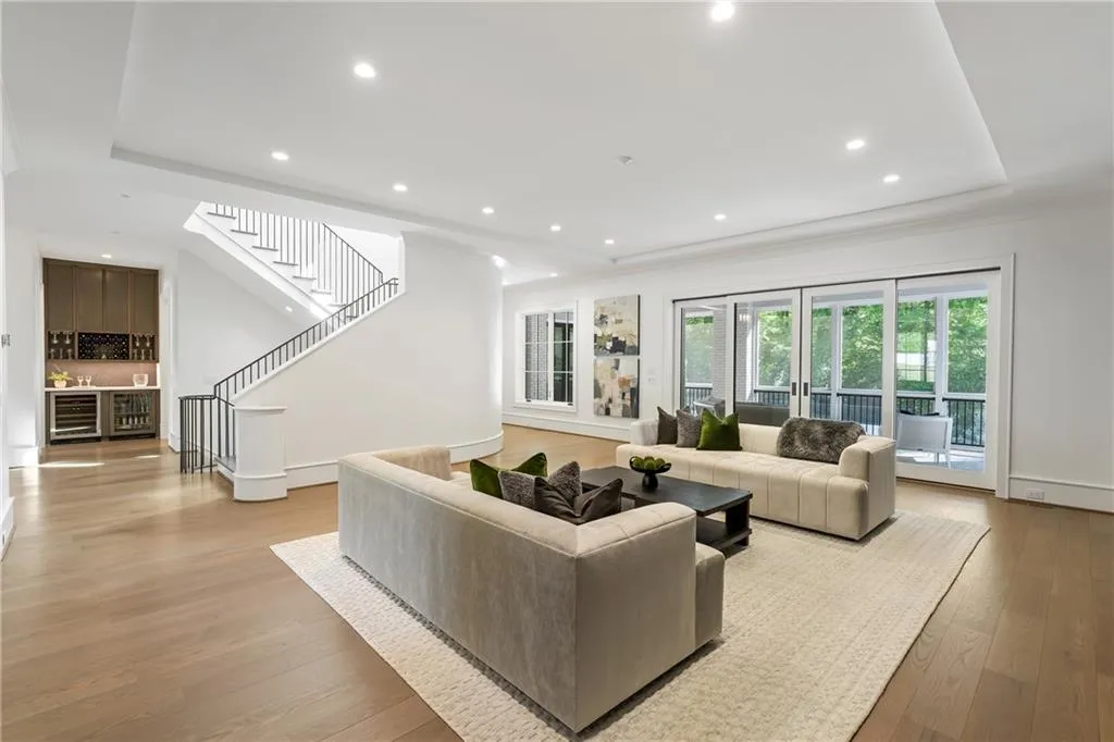 Sliding doors disappear into the walls and open to a screened in porch with beautiful tree lined view of your property