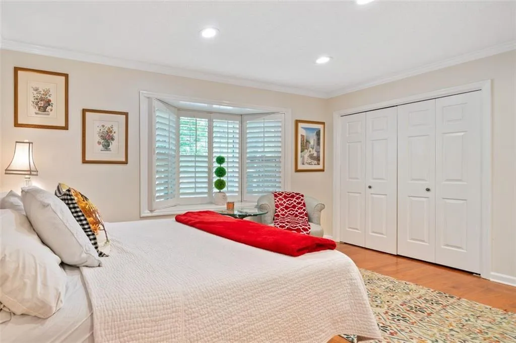 Primary Bedroom, Home Office or Guest Room on main featuring a closet, light hardwood / wood-style flooring, and ornamental molding