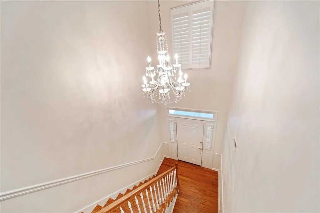 Entryway featuring hardwood / wood-style floors and an inviting chandelier