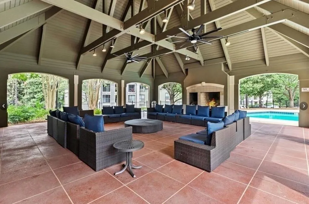 View of patio / terrace featuring an outdoor living space with a fireplace, a ceiling fan, and an outdoor pool