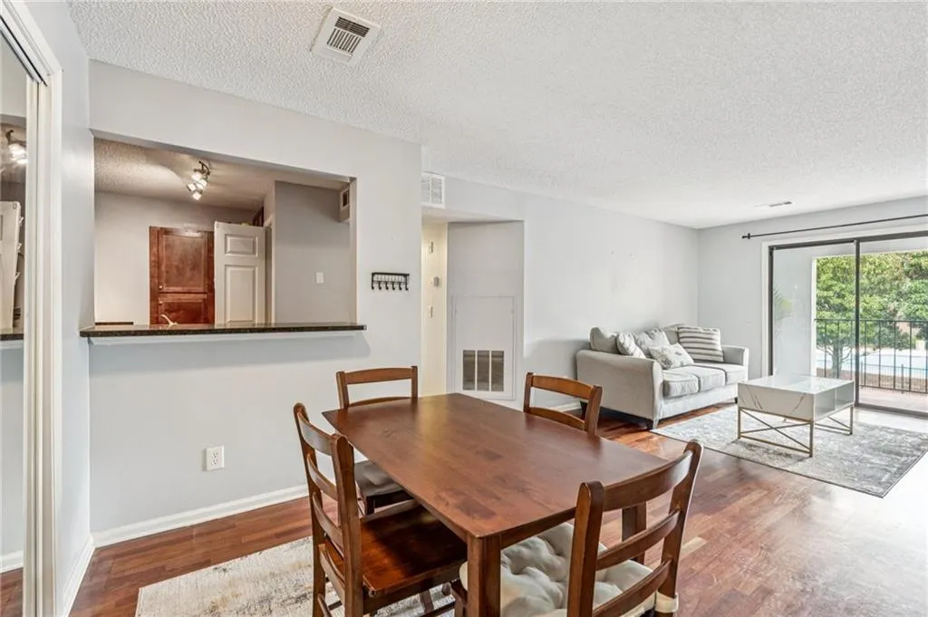 Dining area featuring a textured ceiling and wood finished floors