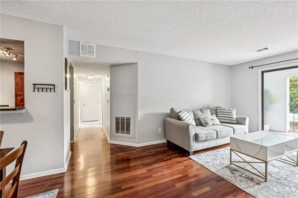 Living area featuring a textured ceiling and wood finished floors