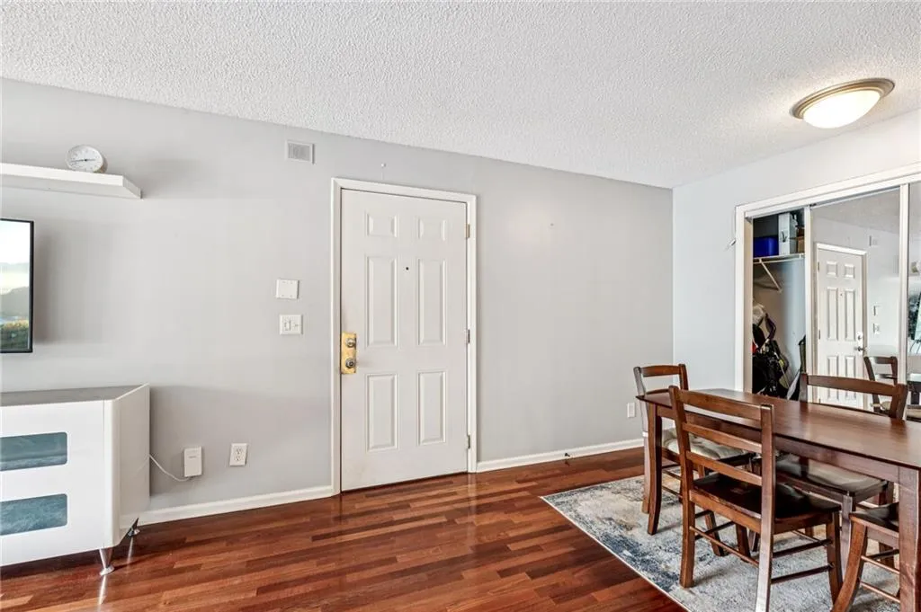 Dining space featuring a textured ceiling and wood finished floors