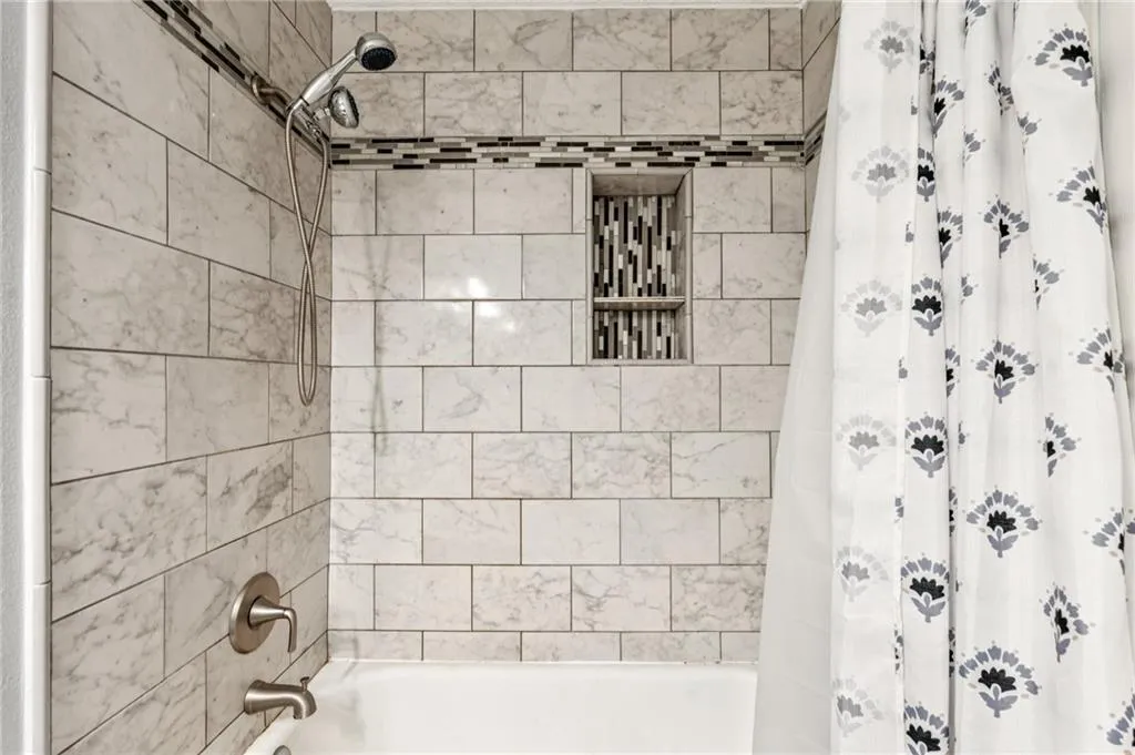 Bathroom featuring shower / bath combo with shower curtain