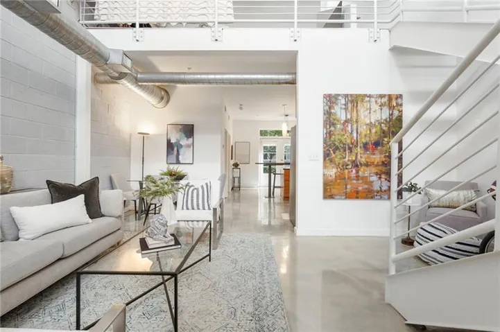 High ceilings, exposed ductwork, and concrete flooring