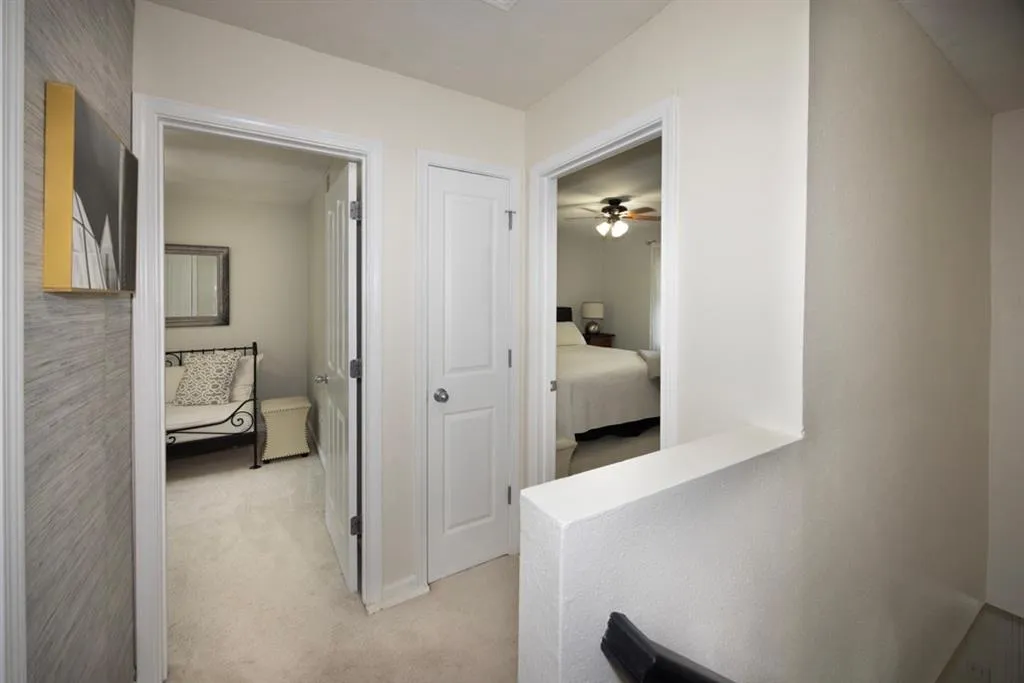 Corridor with light carpet and baseboards