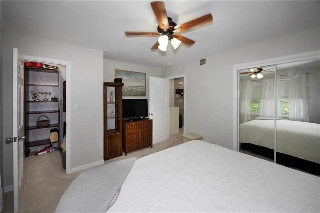 Bedroom with light carpet and ceiling fan