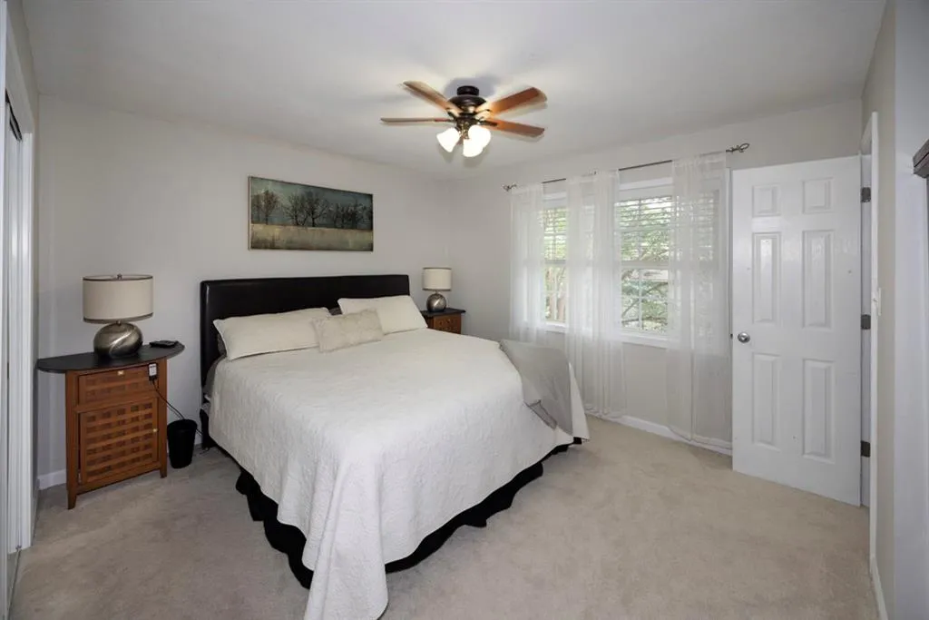 Bedroom with light carpet and ceiling fan